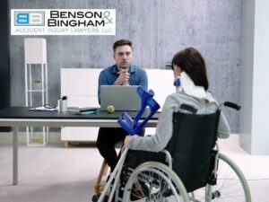 Injury Lawyers consulting with a client in a wheelchair at Benson Bingham