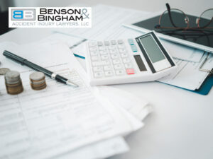 Calculator and documents on a desk, illustrating Medical Expenses & Future Losses