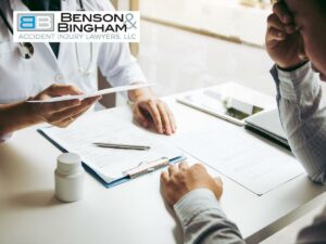 Doctor consulting a patient with documents on a desk, addressing Medical Expenses & Future Losses