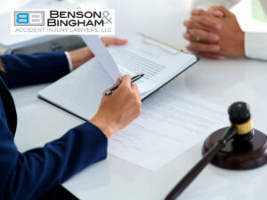 Lawyer reviewing settlement documents with a client at Benson & Bingham