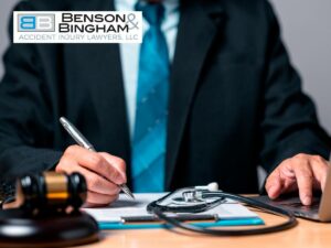 Las Vegas personal injury lawyer at desk with gavel, stethoscope, and laptop.