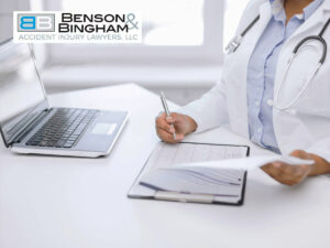 Doctor reviewing paperwork on laptop: dealing with medical providers